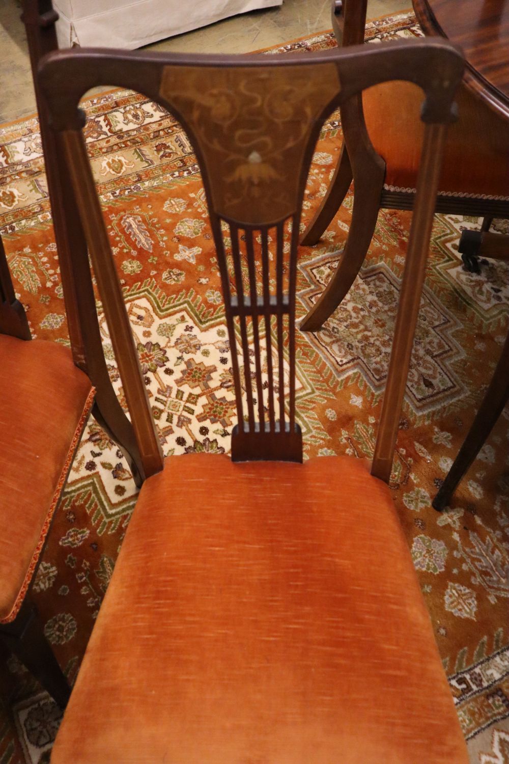 A set of four Hepplewhite style dining chairs (3 single, 1 arm) and four Edwardian dining chairs